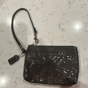 Patent gray Coach wristlet with lavender interior. New without tags.  6.5x5x1.5
